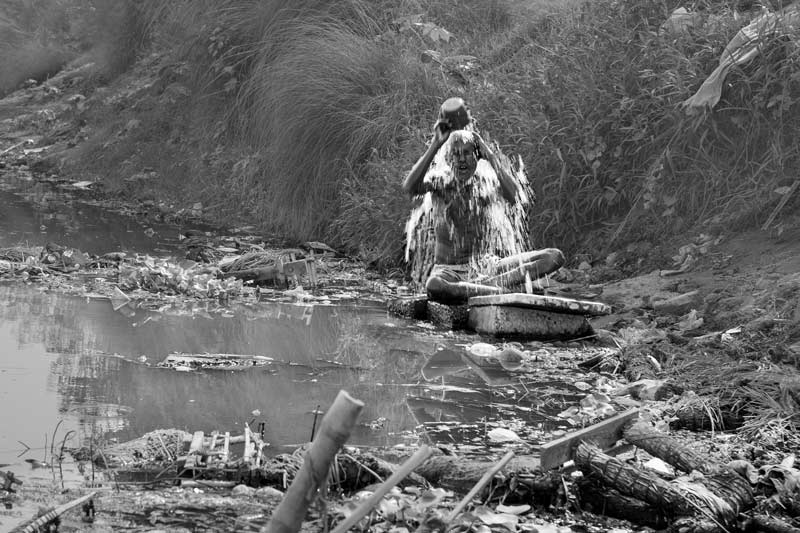 Human Right to Water in Delhi - Bathing on the banks of Yamuna in Delhi using the polluted river water